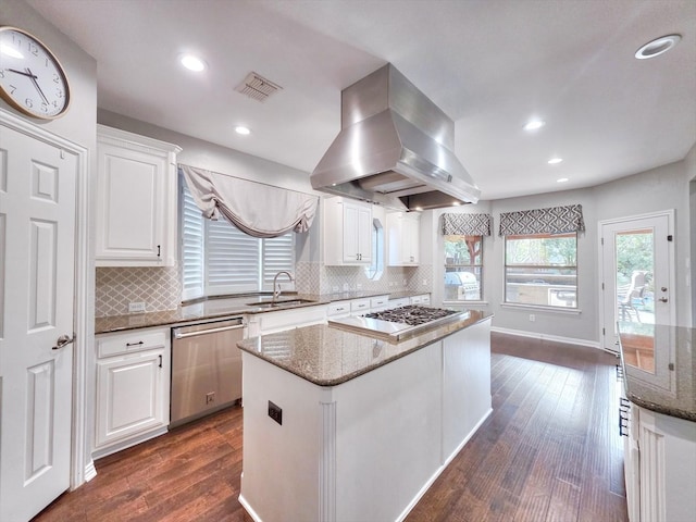 4348 Rice Ln, Carrollton, TX 75010 - kitchen with appliances with stainless steel finishes, island range hood, a kitchen island, dark wood-type flooring, and white cabinets