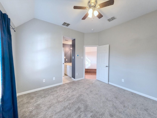 4348 Rice Ln, Carrollton, TX 75010 - unfurnished bedroom featuring light colored carpet, lofted ceiling, ensuite bath, and a ceiling fan