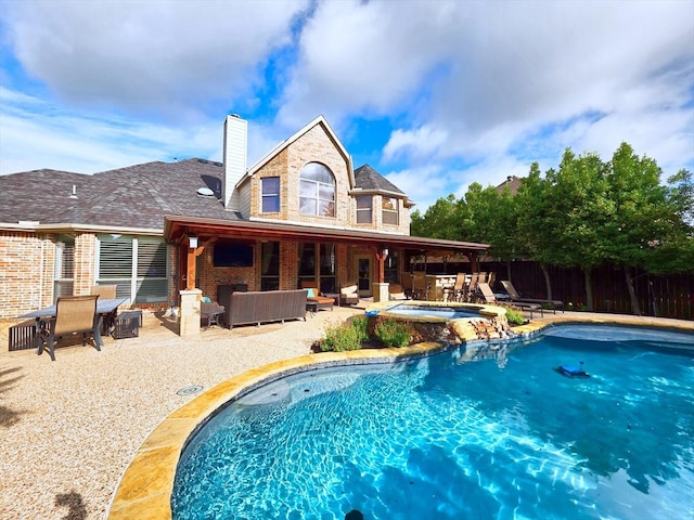 4348 Rice Ln, Carrollton, TX 75010 - rear view of property with outdoor lounge area, brick siding, a patio area, a chimney, and a pool with connected hot tub