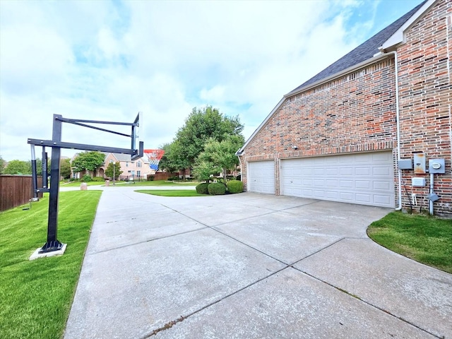 4348 Rice Ln, Carrollton, TX 75010 - view of home's exterior featuring a lawn, brick siding, a garage, and driveway