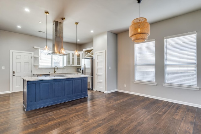619 Buckalew St, Dallas, TX 75208 - kitchen with stainless steel refrigerator with ice dispenser, extractor fan, blue cabinetry, dark wood-style flooring, and a center island