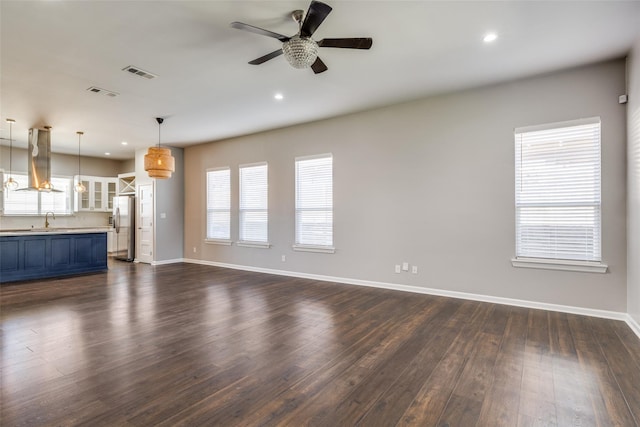 619 Buckalew St, Dallas, TX 75208 - unfurnished living room featuring dark wood-style flooring, a ceiling fan, and recessed lighting
