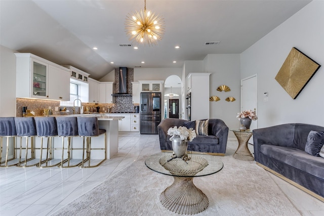 1400 Ambrose Dr, Allen, TX 75002 - living area featuring a chandelier, lofted ceiling, light marble finish flooring, arched walkways, and recessed lighting
