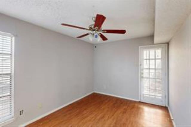 9520 Royal Ln Unit 317, Dallas, TX 75243 - unfurnished room with wood finished floors and ceiling fan