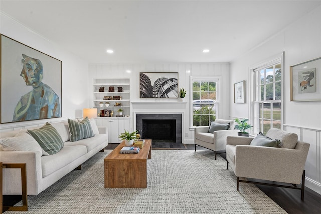 3601 Westcliff Rd S, Fort Worth, TX 76109 - living area with a fireplace with flush hearth, recessed lighting, wood finished floors, crown molding, and built in shelves