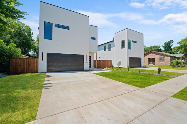 2828 Rochester St, Dallas, TX 75215 - modern home featuring an attached garage, stucco siding, and concrete driveway
