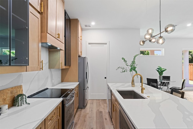 2828 Rochester St, Dallas, TX 75215 - kitchen with appliances with stainless steel finishes, light wood-style floors, light stone countertops, recessed lighting, and hanging light fixtures