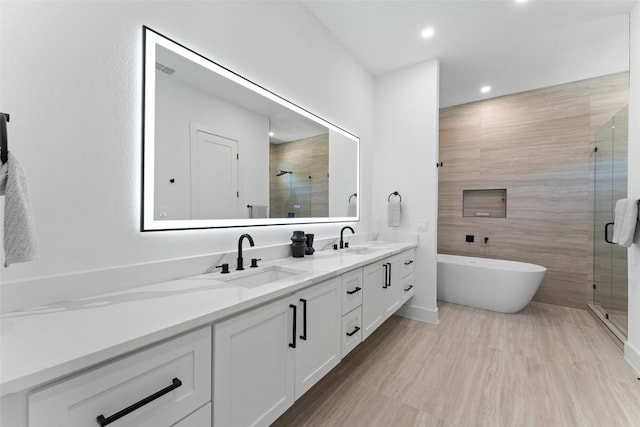 2828 Rochester St, Dallas, TX 75215 - bathroom featuring double vanity, a shower stall, a freestanding tub, and recessed lighting