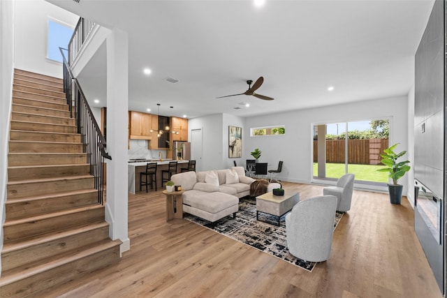 2828 Rochester St, Dallas, TX 75215 - living room with light wood-style flooring, stairway, a ceiling fan, and recessed lighting