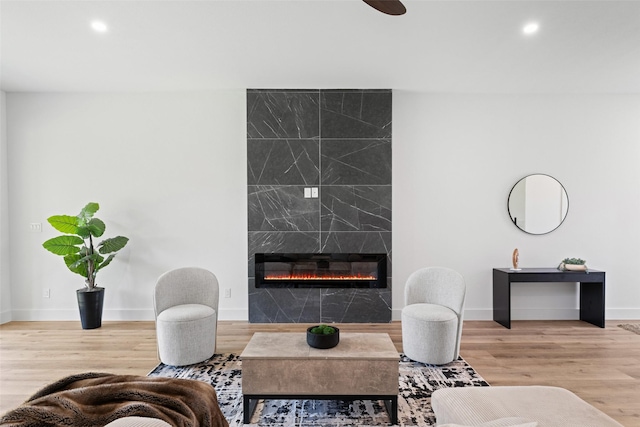 2828 Rochester St, Dallas, TX 75215 - living area with a tile fireplace, wood finished floors, and recessed lighting