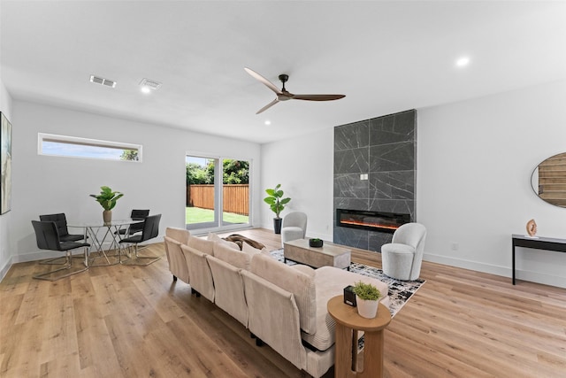 2828 Rochester St, Dallas, TX 75215 - living room featuring a premium fireplace, light wood finished floors, a ceiling fan, and recessed lighting