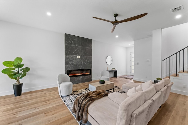 2828 Rochester St, Dallas, TX 75215 - living area featuring a ceiling fan, stairs, wood finished floors, a high end fireplace, and recessed lighting