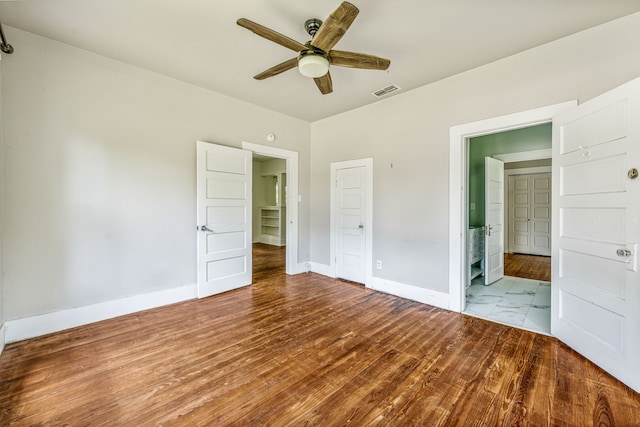 1143 W Jones St, Stephenville, TX 76401 - unfurnished bedroom with a ceiling fan and wood finished floors