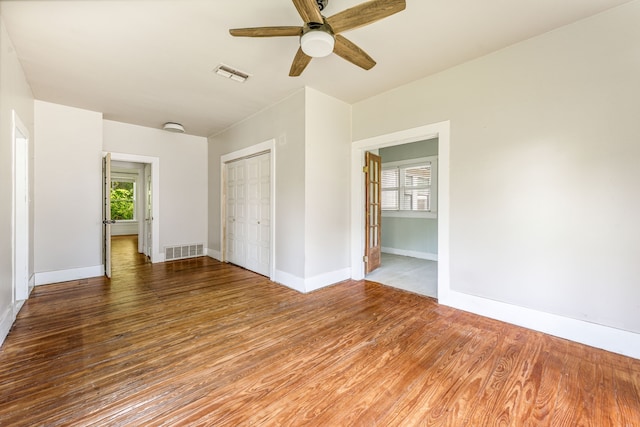 1143 W Jones St, Stephenville, TX 76401 - empty room with wood finished floors, a ceiling fan, and healthy amount of natural light