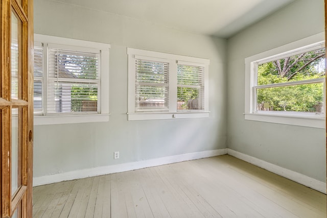 1143 W Jones St, Stephenville, TX 76401 - empty room featuring healthy amount of natural light and hardwood / wood-style floors