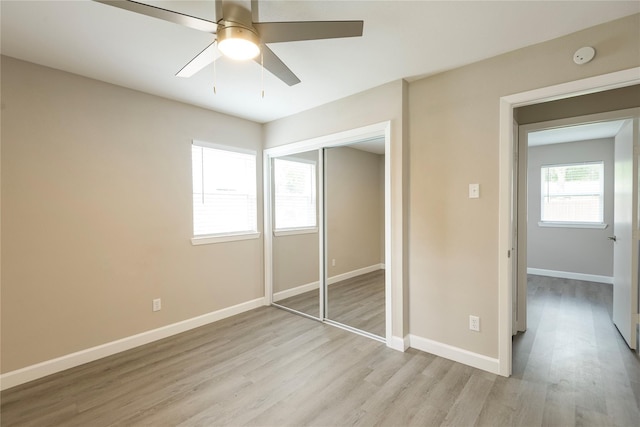311 Ocean Dr, Richardson, TX 75081 - unfurnished bedroom featuring light wood-style flooring, a closet, and ceiling fan