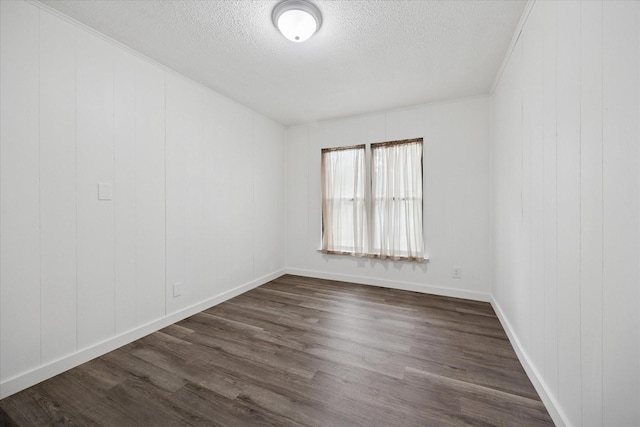 416 W 3rd St, Justin, TX 76247 - unfurnished room with dark wood-style floors and a textured ceiling