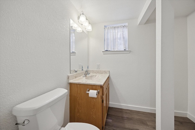 416 W 3rd St, Justin, TX 76247 - bathroom featuring vanity, wood finished floors, and a textured wall