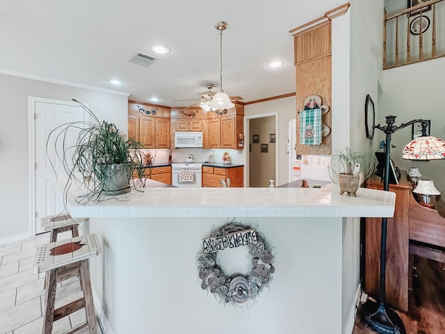 251 Fcr 1171, Fairfield, TX 75840 - kitchen featuring white appliances, tile counters, a peninsula, crown molding, and recessed lighting