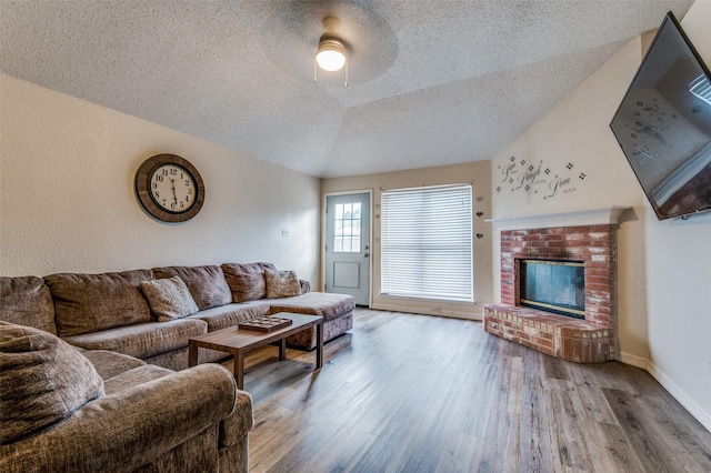 1008 Brook Cyn, Arlington, TX 76018 - living room with a textured ceiling, wood finished floors, a fireplace, and a ceiling fan