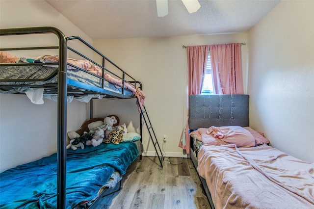 1008 Brook Cyn, Arlington, TX 76018 - bedroom with wood finished floors, a ceiling fan, and a textured ceiling