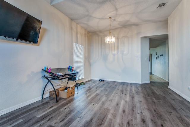 1008 Brook Cyn, Arlington, TX 76018 - dining space featuring a chandelier, wood finished floors, and a textured ceiling