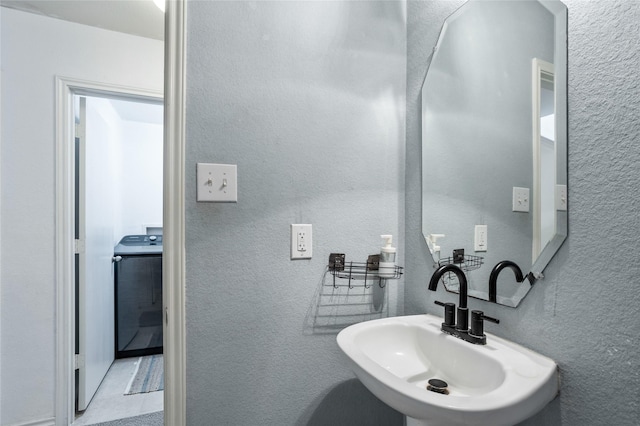 9507 Tallow Berry Dr, Dallas, TX 75249 - bathroom with washer / clothes dryer and a textured wall