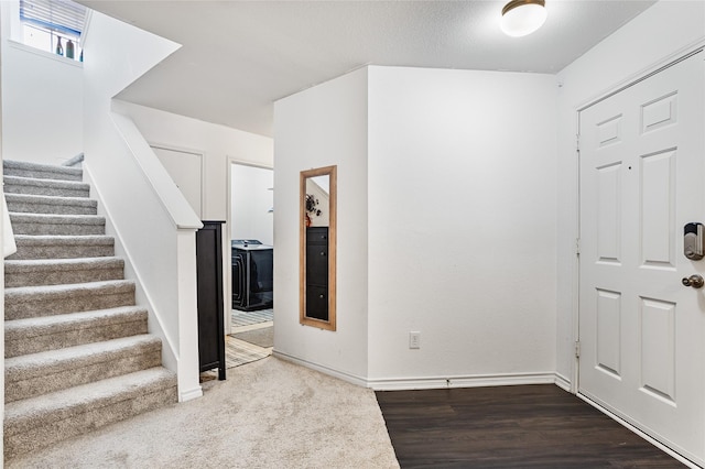 9507 Tallow Berry Dr, Dallas, TX 75249 - foyer entrance with stairs and wood finished floors
