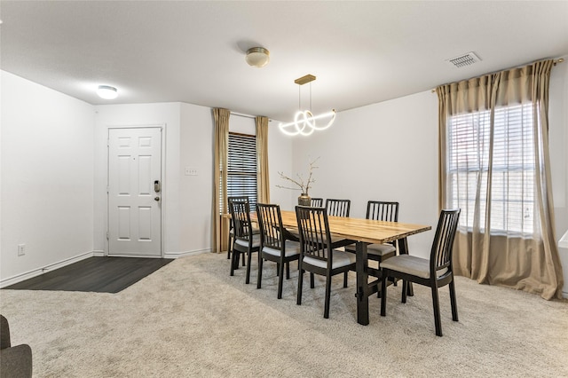 9507 Tallow Berry Dr, Dallas, TX 75249 - dining area with dark colored carpet and a chandelier