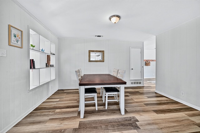 1031 Patricia Dr, Sherman, TX 75090 - dining space featuring wood finished floors, crown molding, and wood walls