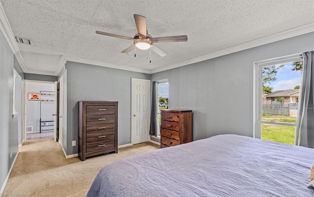 910 Meadowside Cir, Garland, TX 75043 - carpeted bedroom featuring multiple windows, ornamental molding, a textured ceiling, and ceiling fan