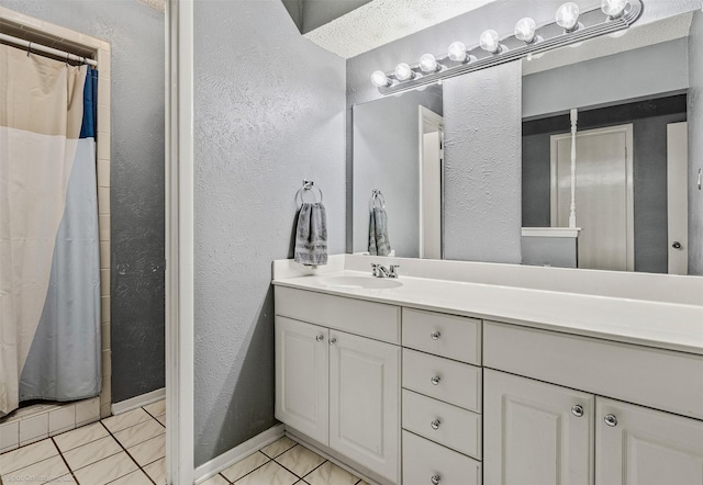 910 Meadowside Cir, Garland, TX 75043 - bathroom featuring a textured wall, vanity, tile patterned floors, and curtained shower