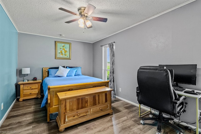 910 Meadowside Cir, Garland, TX 75043 - bedroom with a textured ceiling, crown molding, wood finished floors, an office area, and a ceiling fan