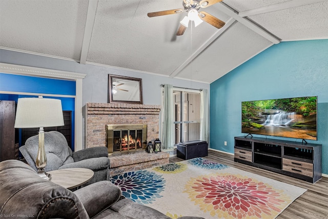 910 Meadowside Cir, Garland, TX 75043 - living area featuring wood finished floors, a textured ceiling, a fireplace, and ceiling fan