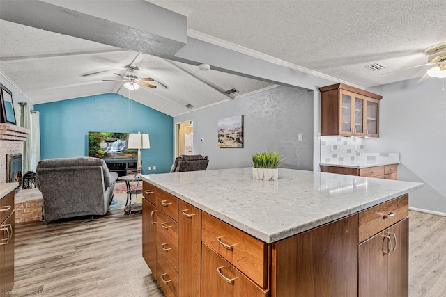 910 Meadowside Cir, Garland, TX 75043 - kitchen featuring ceiling fan, light wood-style floors, a textured ceiling, open floor plan, and lofted ceiling