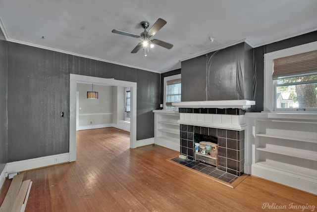 619 College St, Shreveport, LA 71104 - unfurnished living room featuring a ceiling fan, wood-type flooring, and crown molding