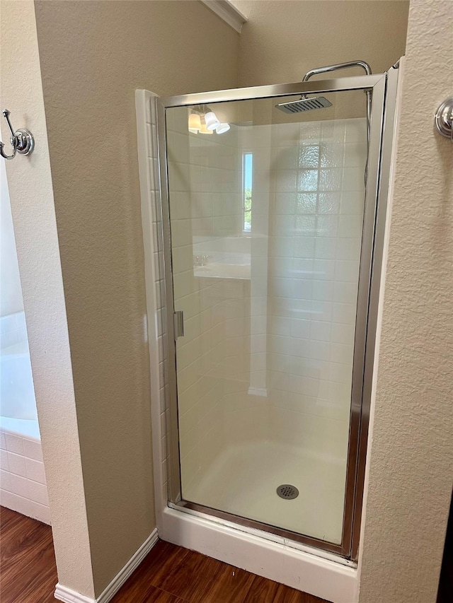 2717 Big Spring Dr, Fort Worth, TX 76120 - full bath featuring a textured wall, wood finished floors, and a shower stall