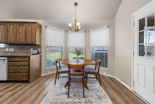 5520 Plata Ln, Benbrook, TX 76126 - dining room with healthy amount of natural light, a chandelier, and wood finished floors