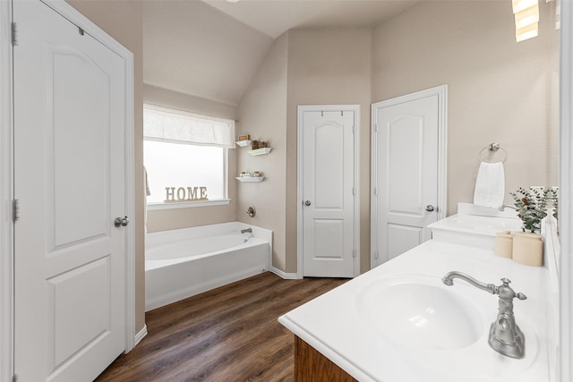 5520 Plata Ln, Benbrook, TX 76126 - full bathroom featuring vaulted ceiling, double vanity, wood finished floors, and a bath
