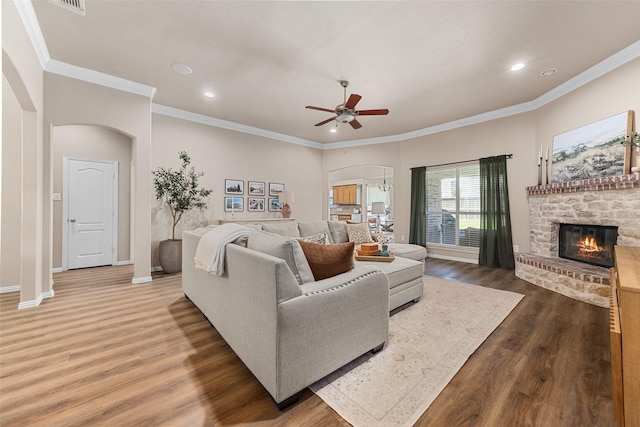 5520 Plata Ln, Benbrook, TX 76126 - living room with arched walkways, wood finished floors, a ceiling fan, a fireplace, and recessed lighting