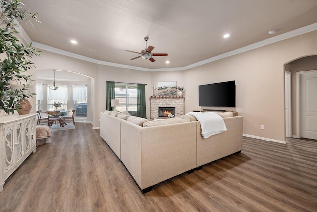 5520 Plata Ln, Benbrook, TX 76126 - living area featuring arched walkways, wood finished floors, a ceiling fan, a stone fireplace, and recessed lighting
