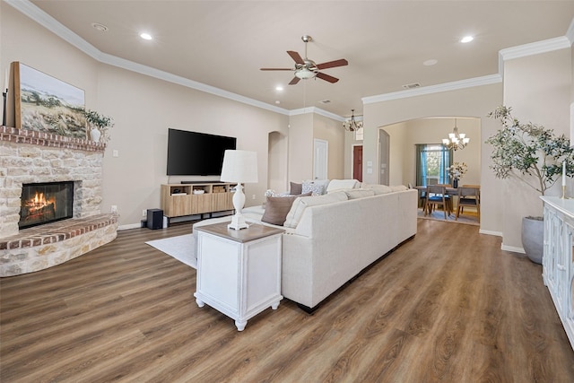 5520 Plata Ln, Benbrook, TX 76126 - living area with a chandelier, a ceiling fan, a fireplace, arched walkways, and recessed lighting