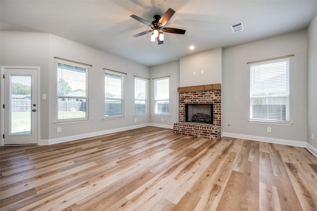 1402 N Mason St, Bowie, TX 76230 - unfurnished living room with light wood-style flooring, ceiling fan, a fireplace, and recessed lighting