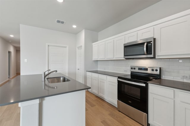 1113 Little Hills Way, Lavon, TX 75166 - kitchen featuring stainless steel appliances, dark countertops, backsplash, light wood-type flooring, and recessed lighting