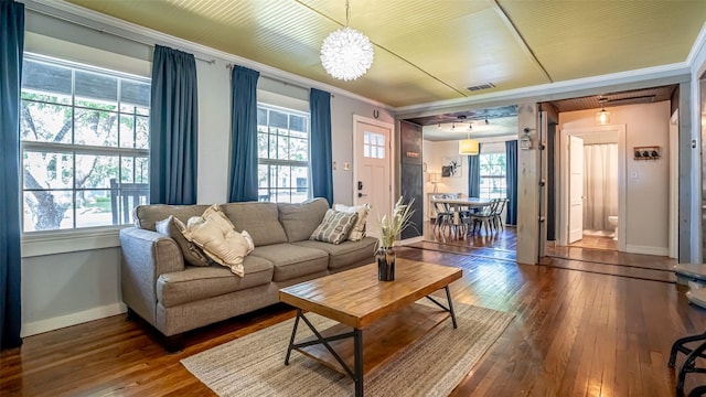 1250 N Isla St, Stephenville, TX 76401 - living area featuring wood-type flooring, a chandelier, ornamental molding, and healthy amount of natural light