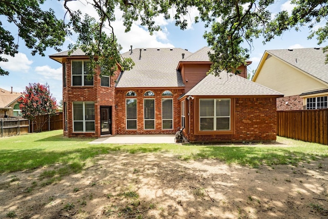 2309 Chambray Dr, Corinth, TX 76210 - rear view of house with brick siding, a shingled roof, a patio, and a fenced backyard