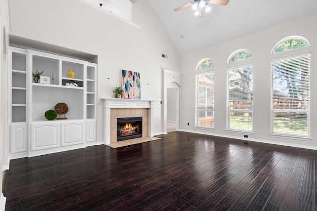 2309 Chambray Dr, Corinth, TX 76210 - unfurnished living room featuring ceiling fan, a tile fireplace, wood-type flooring, healthy amount of natural light, and high vaulted ceiling