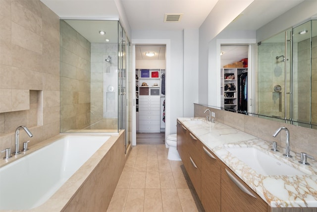 2900 Mckinnon St Unit 1001, Dallas, TX 75201 - full bath with a spacious closet, a stall shower, double vanity, and tile patterned flooring