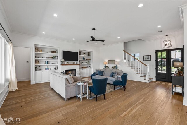 10946 Whispering Path Dr, Shreveport, LA 71106 - living room featuring a ceiling fan, ornamental molding, light wood-style floors, a lit fireplace, and recessed lighting