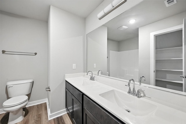 324 W Munson St Unit 326, Denison, TX 75020 - bathroom featuring wood finished floors and double vanity